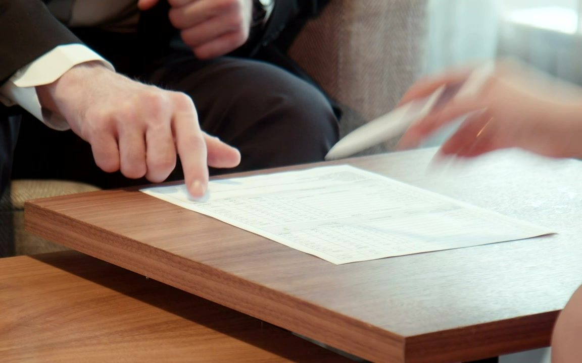 Hands reviewing a loan document
